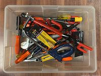 Clear plastic bin containing assorted hand tools