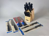 Photo showing sealed TRAMONTINA knives and Farberware knife block with knives.