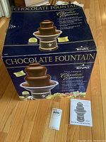 Original box for Rival chocolate fountain showing product image and promotional text.