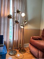 Front view of both floor lamps showing overall design and scale