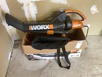 Worx corded leaf blower on the box, showing side profile with nozzle and handle