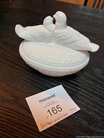 Top and side view of white milk glass candy dish with doves on lid