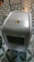 Front view of Tosot portable air conditioner showing control panel with digital numeric display and air vent.