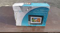 Original box packaging of the Omnitech 7 inch digital photo frame, showing product image and branding.