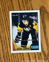Front of 1987-88 O-Pee-Chee Mario Lemieux hockey card showing the player in Pittsburgh Penguins uniform.