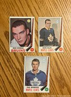 Front of three 1969-70 O-Pee-Chee hockey cards: Ken Hodge (Bruins), Ron Ellis and Paul Henderson (Maple Leafs).