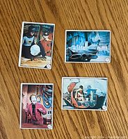 Front view of (4) 1966 Batman cards showing Batman, Robin, Joker, Batmobile and Batcycle in color image scenes from the TV show.