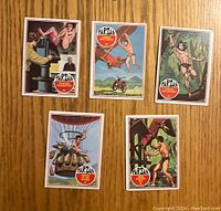 Front sides of the 5 colorful vintage Tarzan cards showing various action scenes and jungle settings.