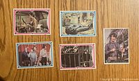 Front of 5 vintage The Monkees cards showing characters and scenes with colorful borders.