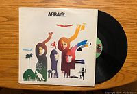Front cover art of ABBA vinyl album showing stylized portraits of the band members in colorful silhouettes and small icons.