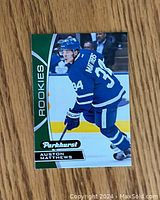 Front of Auston Matthews Parkhurst rookie card showing image of player skating with team jersey and rookies label