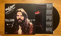 Front cover of Bob Seger Stranger in Town vinyl LP showing artist portrait with city lights background and vinyl record partially visible.