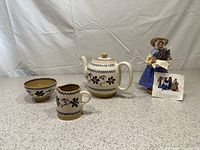 All four items: Nicholas Mosse Clematis Pottery set (teapot, sugar bowl, creamer) with Santons lavender lady clay figure in background.