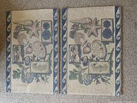Top side view of two identical ocean and shell-themed cotton accent rugs with various shells and starfish on a cream background with blue border.