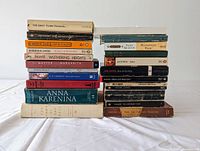 Two stacks of classical fiction books seen from front with titles visible to identify authors and works.
