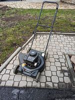 Front and top view of the black Murray gas lawn mower on a paved surface.