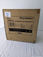 Photo of the STANDARD brand LED ceiling light fixtures' packaging box showing model number 65612, technical specs, and quantity of 2.