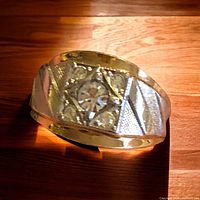 Close-up of the ring top showing central stone and decorative design