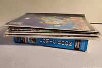 Side view showing thickness of comic books and price guide in protective sleeves.