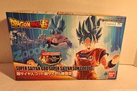 Front box image showing Super Saiyan God Super Saiyan Son Goku with action pose and Dragon Ball Super logo. Box indicates all pieces remain in packaging.