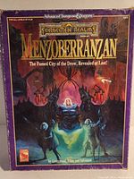 Front of the Menzoberranzan boxed set showing title and fantasy art with spiders and characters.