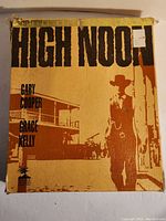 Front view of the High Noon collector's edition box showing the damaged corners and artwork in shades of brown and tan.