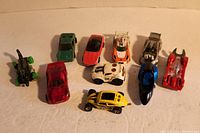 Lot of 10 Hot Wheels cars shown from top angle, displaying colors and styles.