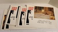 Stack of six 11" by 8" Scarface movie posters showing front and back sides, edges with small damage.
