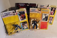 Four Starting Lineup sports action figures in original packaging with some visible packaging wear.