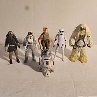 Set of six Star Wars action figures arranged in a row on a plain surface against a plain background.