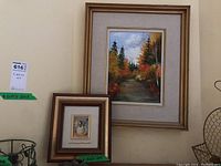 Two framed art pieces: large oil painting on board of a forest landscape and smaller framed limited edition silver artwork of roses.