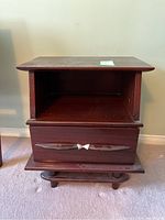 Front view of the mahogany Gibbard end table showing drawer and open shelf