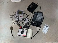 Overview of all items: Game Boy, Polaroid Swinger, Polaroid Land camera, Sony Walkman, headset and adapter cables