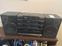 Front view of Sony CFD-460 stereo system showing central unit and two matching speakers on each side.