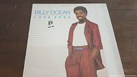 Front cover of Billy Ocean Love Zone vinyl album showing Billy Ocean in reddish suit against white background