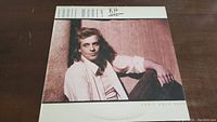 Front cover of Eddie Money's 'Can't Hold Back' vinyl album showing photo of Eddie Money sitting relaxed against a wall.