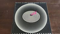 Front cover of Queen's Jazz album showing concentric circles and title.