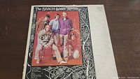 Front cover of The Beach Boys vinyl album; color photo of band members with decorative border.