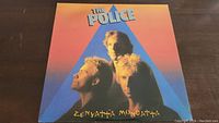 Front cover of The Police Zenyatta Mondatta vinyl album showing the band members and album title.