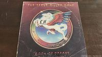 Front cover of The Steve Miller Band Book of Dreams vinyl record album showing Pegasus logo with some wear and handwritten marks.
