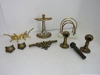 Wide view of all vintage brass items arranged on white surface