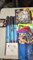 Photo showing rollable chalkboards, glitter paper, letter stickers, pastel chalks, and an art poster set.