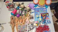 Overview of lot contents including 5 naked Barbie dolls, Ariel Funko Pop, mini wrestler figurines, mini Buzz Lightyear figure, books, and small toys
