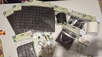 Wide shot of all items in the pegboard organizer set laid on a flat surface showing various containers, hooks, and accessories in original packaging.