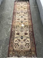 Full view of hallway rug on concrete floor.