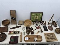 Photo showing the entire vintage collection including kitchen tools, bowls, plaques, and figurines on a white table.