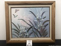 Framed oil painting showing white flowers and butterflies with soft background, measuring 25 1/2 x 21 1/2 inches.