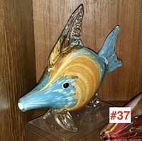Front angle of the blue and amber art glass fish sculpture showing detailed snout and fins.