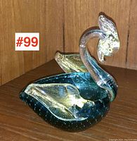 Side view of teal Murano glass swan bowl with clear neck and gold inclusions, showing the curved neck and wings.