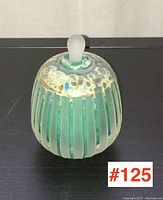 Front side view of the vintage art glass perfume bottle showing the striped design and frosted stopper.